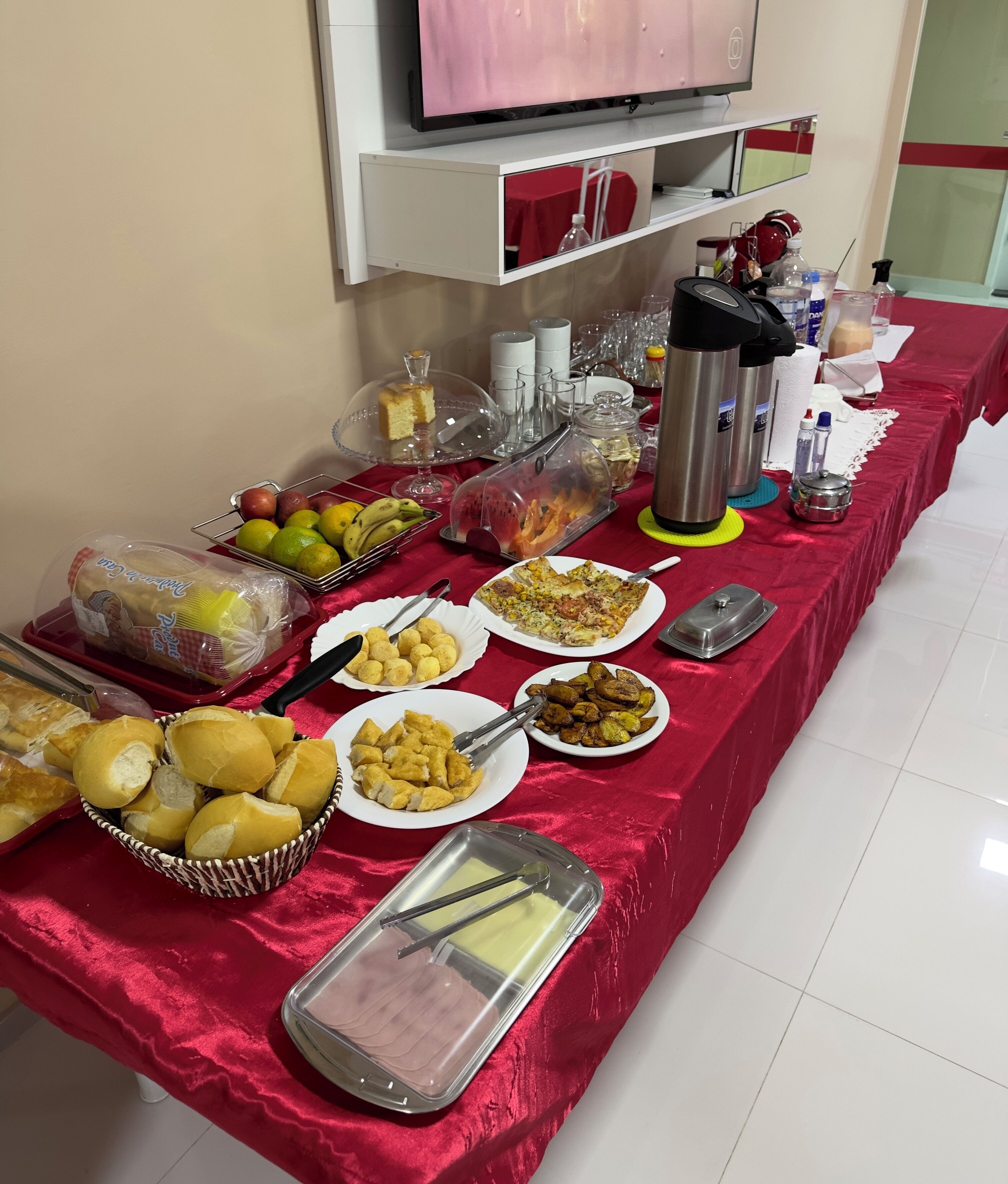 A buffet table with various food items and utensils.