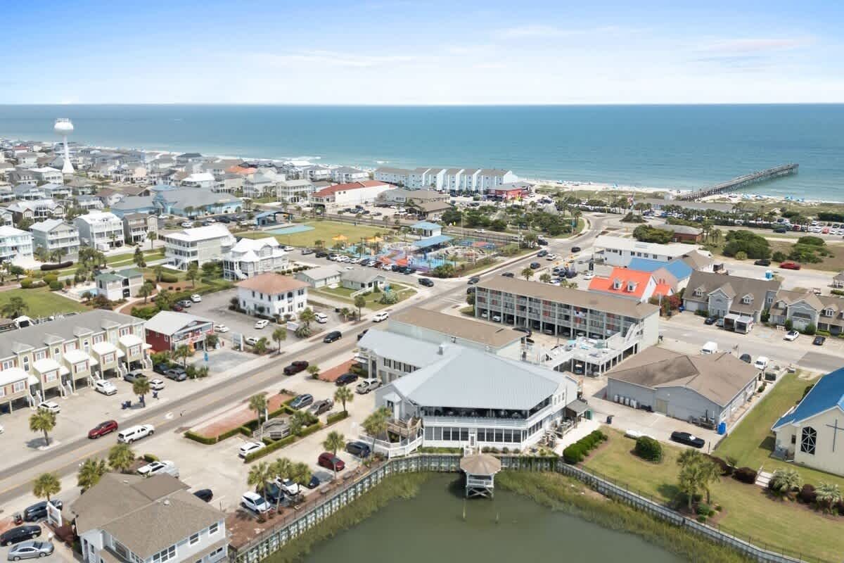 A coastal town with a marina, residential buildings, and a prominent church.