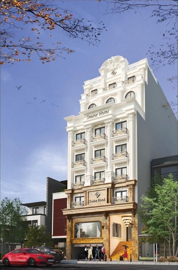 A hotel with a classic architectural design, featuring multiple balconies and a prominent entrance. - Senior Hotel (Can Tho)