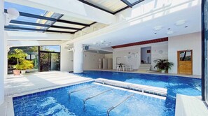 An indoor swimming pool with clear glass ceilings, a sunlit room with a door, and a view of the outside. - Nonsmoking Main building maisonette room 1F Jap / Konan Kōchi (Konan)