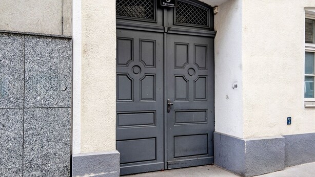 A double door with a number plaque, a stone wall, and a small window. - Delightful Josefstadt 3BR, Furnished + Open Design, by Blueground (Vienna)