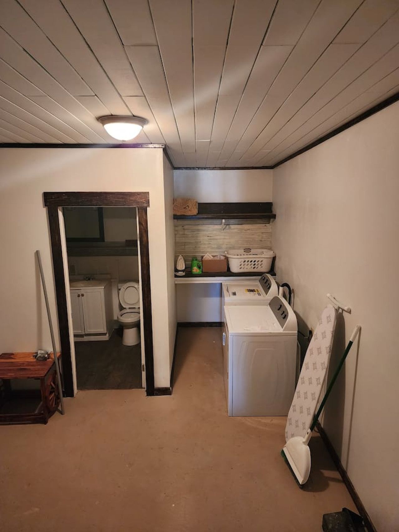 A laundry room with a washing machine, a dryer, and a folding table.
