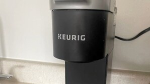 A black Keurig coffee machine on a kitchen counter.