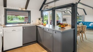 A modern kitchen with a large island, a dishwasher, and a window overlooking greenery. - "Gyrial" - 2km from the sea by Interhome (Blåvand)