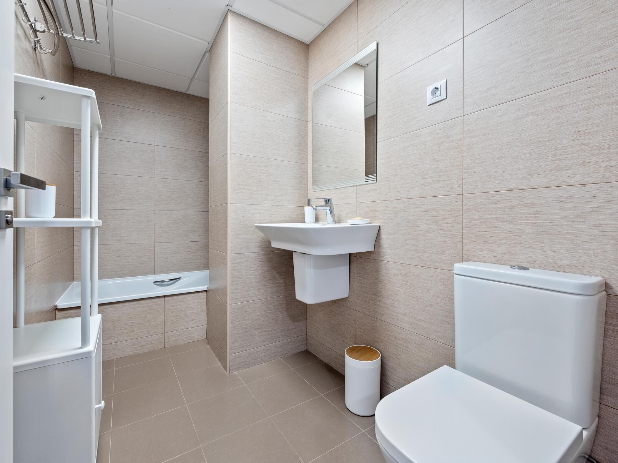 A modern bathroom with a toilet, sink, and shower.