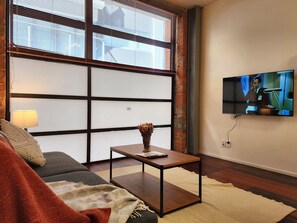 Deluxe Apartment | Living area | 55-inch Smart TV with digital channels