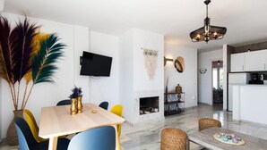 A modern living space with a dining area, kitchen, and seating area. - Coral Island, Mediterranean Duplex Penthouse (BENALMADENA COSTA)