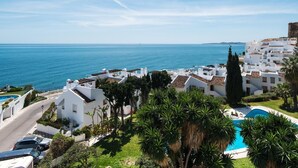 A coastal town with white buildings, a clear blue sky, and a view of the sea. - Coral Island, Mediterranean Duplex Penthouse (BENALMADENA COSTA)