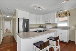 Enjoy cooking in this well-equipped kitchen with a central island and stainless steel appliances.