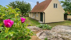 A small, single-story house with a sloped roof and a green door. - "Øde" - 100m from the sea by Interhome (Svaneke)