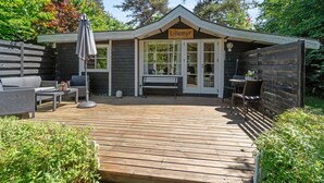 A wooden deck with outdoor furniture, a bench, and a sign reading "Lillemyr". - "Konrad" - 270m from the sea by Interhome (Nexø)