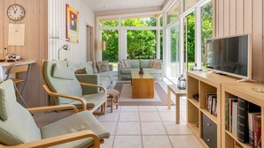 A spacious living room with a large TV, comfortable seating, and a bookshelf. - "Dagny" - 100m from the sea by Interhome (Knebel)