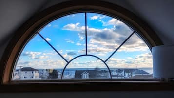 Enjoy a view of the coastal area from the large window with a clear view of the sky and sea.