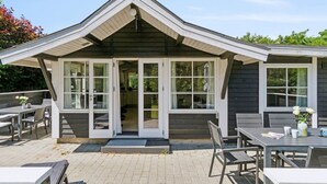 A modern house with a covered patio area featuring outdoor seating. - "Horsten" - 270m from the sea by Interhome (Nexø)