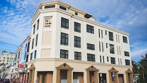 A corner building with multiple windows and a sign indicating it is "The Corner House". - The Corner House (Kuala Belait)