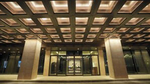 A hotel entrance with a modern design, featuring a geometric ceiling pattern and a glass door entrance. - Millennium Al Masar Hotel (Jeddah)
