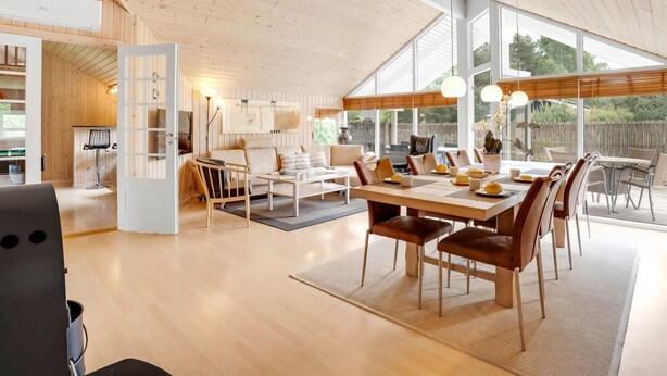 A spacious, modern interior with a wooden ceiling and large windows.