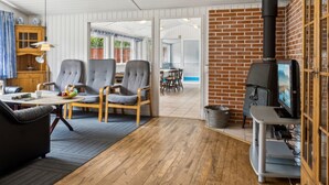 A cozy living room with a fireplace, comfortable seating, and a view of the outdoor area. - "Fritza" - 500m from the sea by Interhome (Fårevejle)
