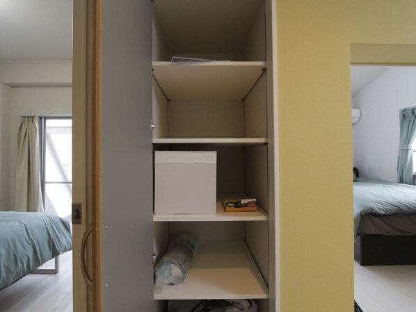 A room with a bed, a wardrobe, and a window.
