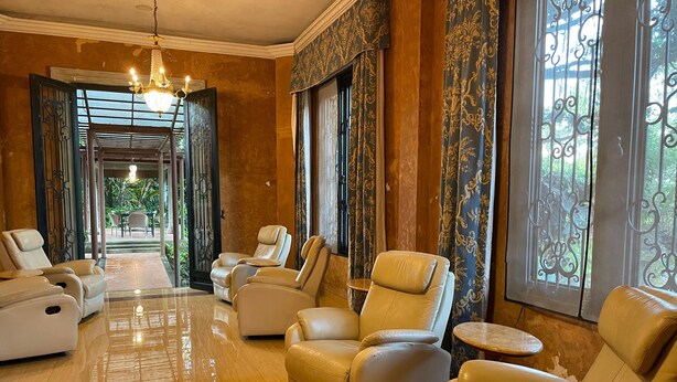 A spacious lounge area with leather armchairs and a polished wooden floor. - Kaliandra Eco Resort & Organic Farm (Prigen)