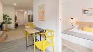 Un dormitorio moderno con una cama, mesita de noche y una lámpara.
