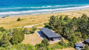 A modern house with a large deck overlooking a beach and ocean. - "Rakita" - 75m from the sea by Interhome (Sjællands Odde)