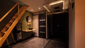 A modern bathroom with a glass shower enclosure, a wooden staircase, and a vanity with a mirror. - Chambre d'hôte with private spa, whirlpool bath and infrared sauna (Boëseghem)