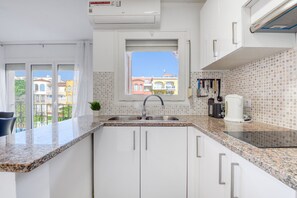 Fridge, microwave, coffee/tea maker, cookware/dishes/utensils