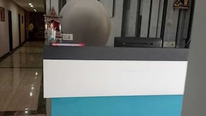 A reception desk with a modern design, featuring a large spherical object on top and a blue and white color scheme. - The Elephant Hotel (Rohtak)