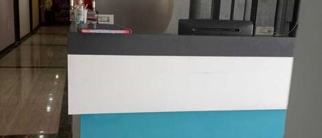 A reception desk with a modern design, featuring a large spherical object on top and a blue and white color scheme.