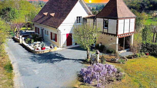A traditional building with a sloped roof, a small tower, and a paved driveway. - LA BAYARDINE (Sarlat-la-Canéda)