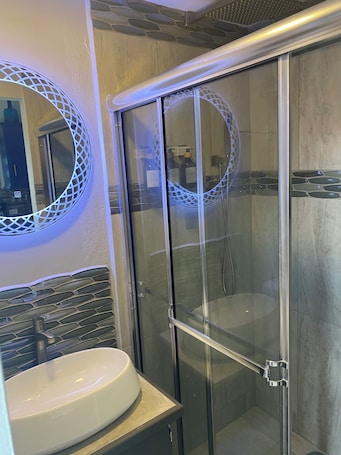 Shower, hair dryer, towels, soap. TinyUrb, a modern tiny house, big on comfort but with tiny living experience.