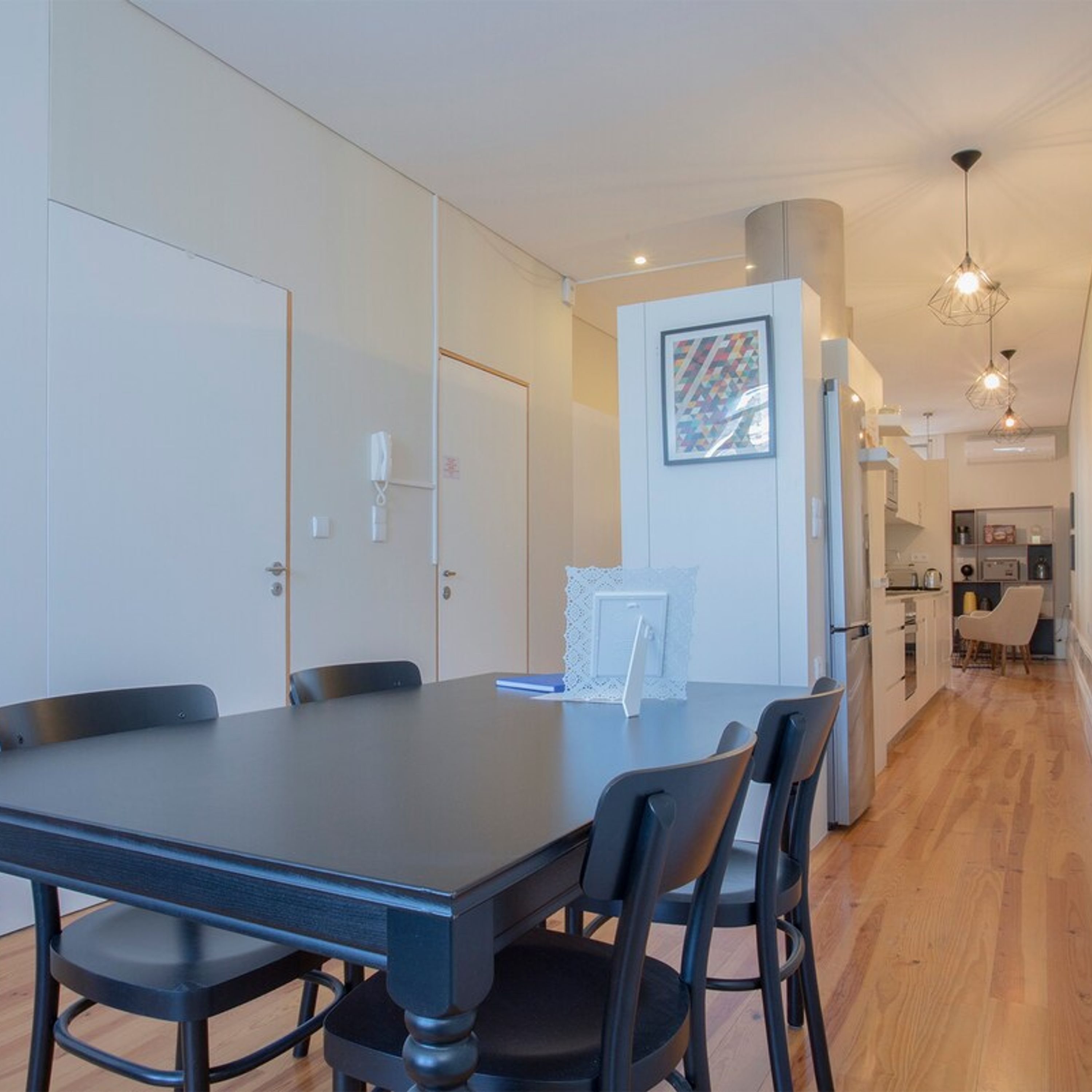 A modern kitchen with a dining area.