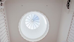 A room with a skylight, stone floor, and white railings. - Liiiving in Porto Downtown Luxury Apartment 1R (Porto)