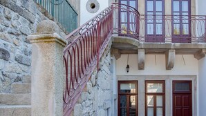 A narrow stone staircase with a wrought iron railing leading to a second-floor balcony. - Liiiving in Porto Downtown Luxury Apartment 1R (Porto)
