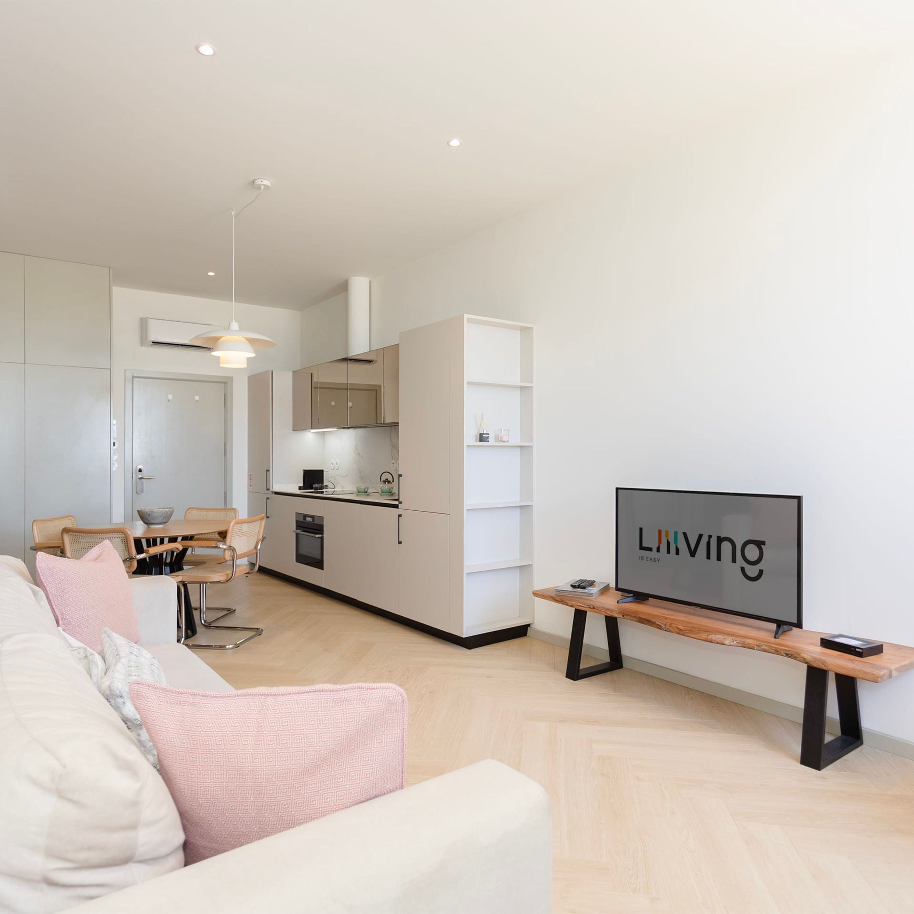 A modern apartment with a living room, kitchen, and dining area.