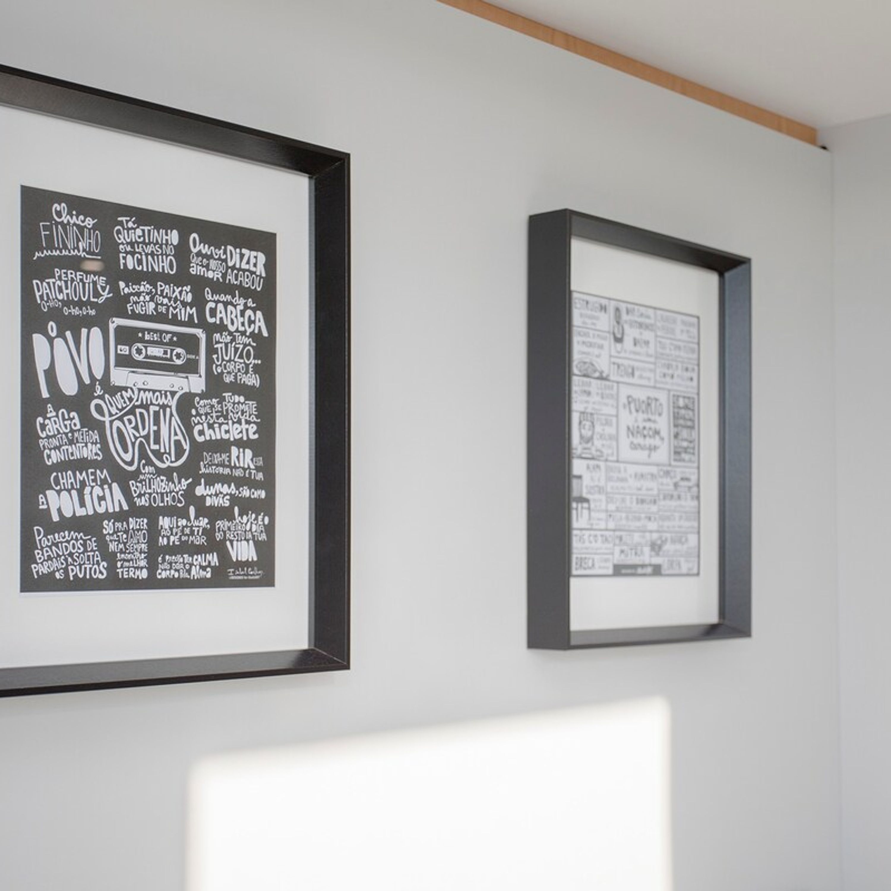 Two framed artworks on a wall.