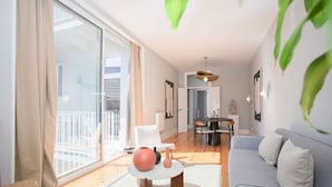 Un salon moderne avec un canapé, une table basse et un coin repas.
