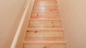 A wooden staircase with a handrail, leading to a doorway. - Liiiving in Porto Historic Cl Rigos Studio - 4F (Porto)