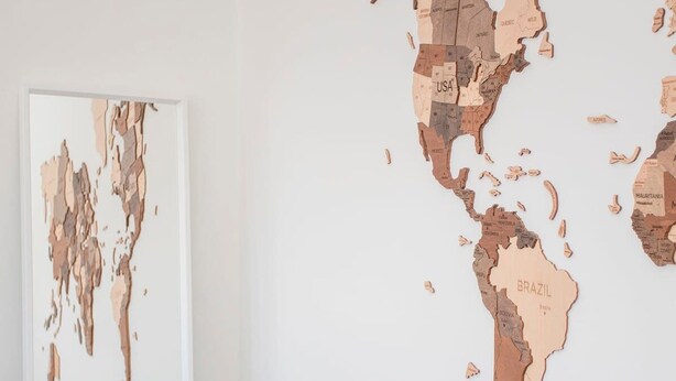 A large, abstract wooden map installation on a wall. - Liiiving in Porto - Downtown Balcony Apartment (Porto)