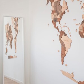 A large, abstract wooden map installation on a wall. - Liiiving in Porto - Downtown Balcony Apartment (Porto)