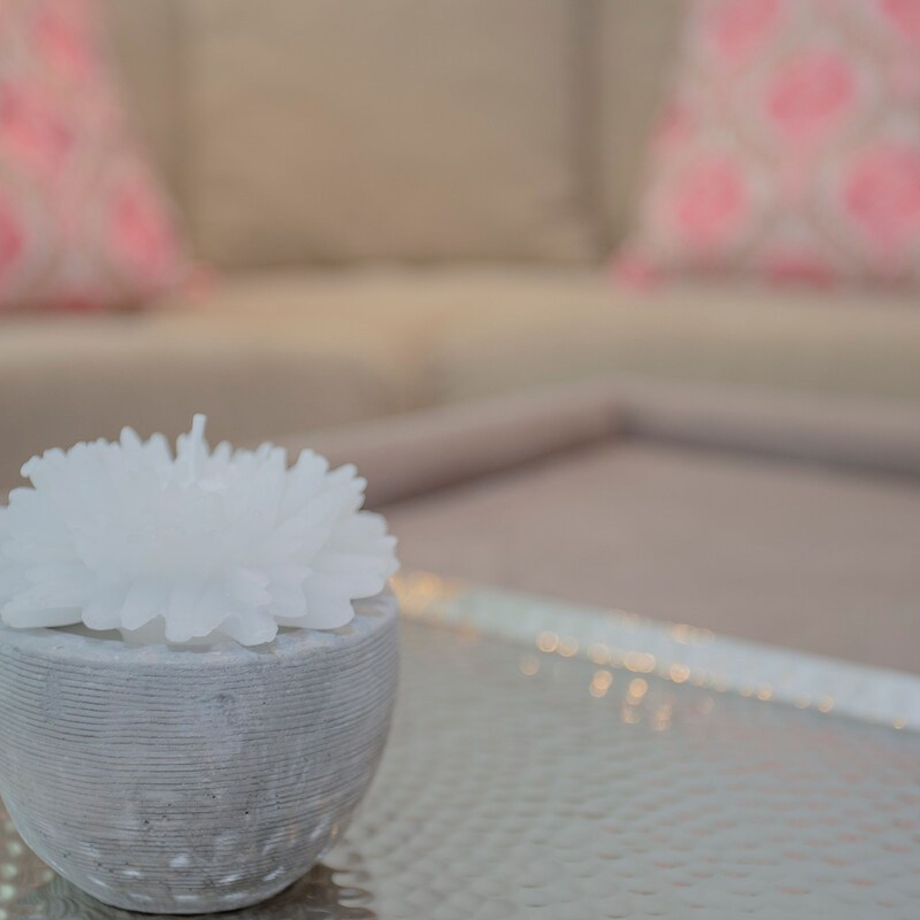 A small bowl of white sugar on a textured surface.