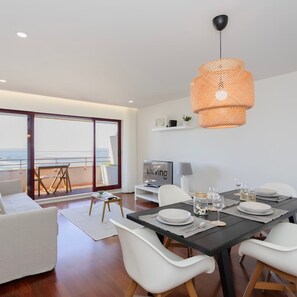 Enjoy meals with a view of the sea from this dining area with a large table for two.