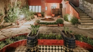 A modern building with a courtyard, outdoor seating, and potted plants. - Liiiving in Porto - Casa Duque Apartment III (Porto)