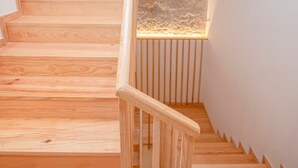 A wooden staircase with a glass panel on the right side. - Liiiving in Porto-mouzinho Residence Apartment 2F (Porto)