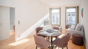 A modern apartment with a dining area, a staircase, and a sofa. - Liiiving in Porto-mouzinho Residence Apartment 2F (Porto)
