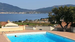 A swimming pool with a view of a coastal town and mountains in the background. - 3-room apartment with pool, AC and Wi-Fi in Porticcio (Porticcio)