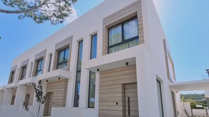 A modern two-story building with large windows and a flat roof. - Stay Sunshine Aura in Protaras (Paralimni)