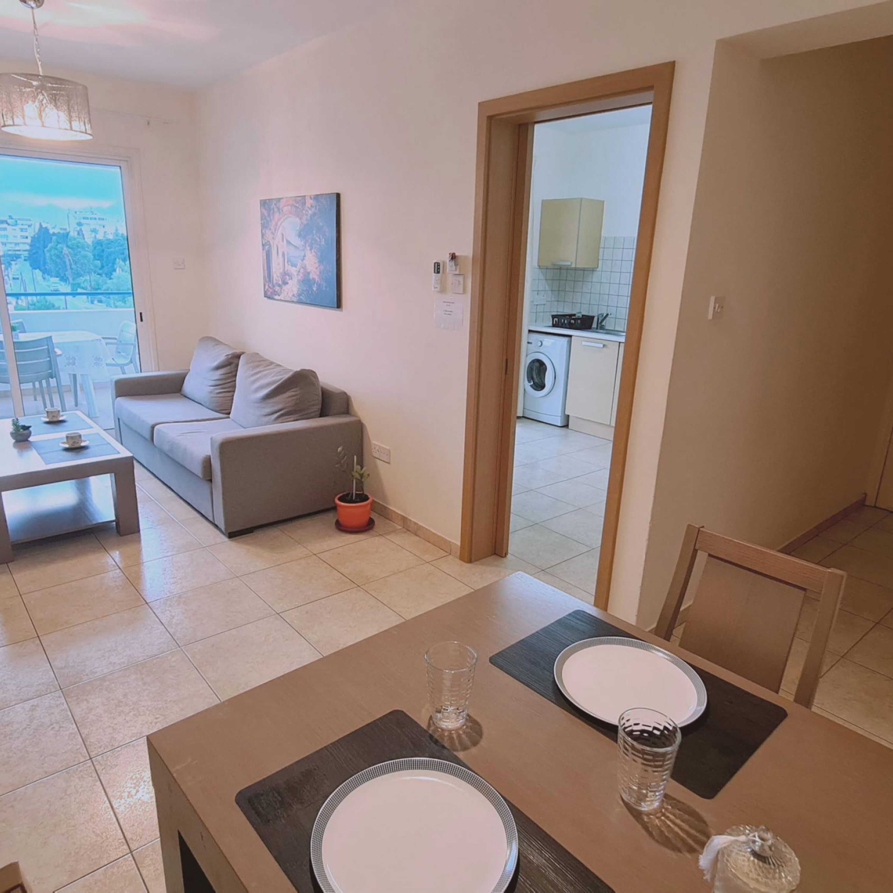 A modern apartment with a living area, dining space, and a kitchen.