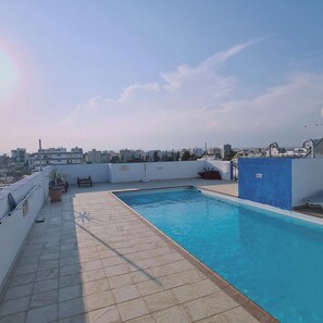 A rooftop pool with a clear view of the cityscape in the background. - 13 LCA - Stay Suncity Apartment (Larnaca)